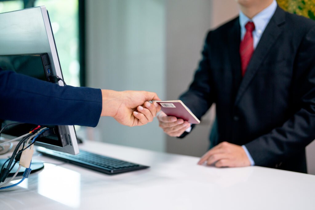 Close up hands of the customer give passport book to airline staff for flight at service counter