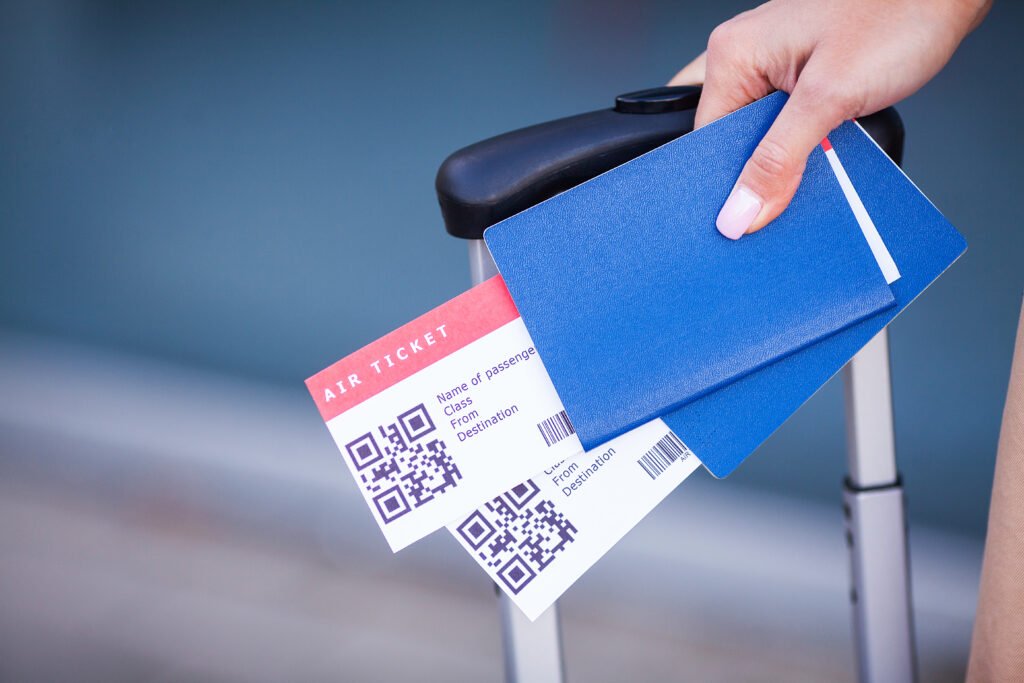 Passports and tickets for flight on hand of woman